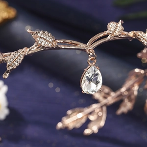 Detail of rose gold leaf headpiece with sparkling rhinestones and waterdrop crystal