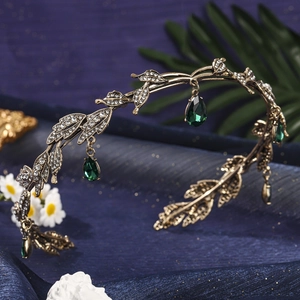 Vintage bronze leaf crown with green waterdrop gems and diamonds on blue silk