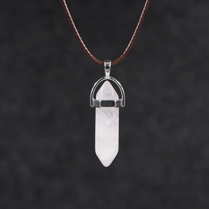 Detail of hexagonal pink quartz crystal pendant with silver clasp on brown cord