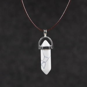 Detailed view of hexagonal white turquoise pendant with silver clip and brown wax cord