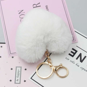 Macro detail of white plush heart keychain with premium gold lobster clasp and ring
