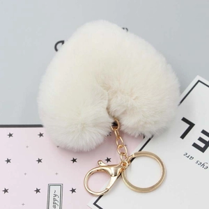 Detail of off-white heart faux fur keychain with golden spring hook and ring