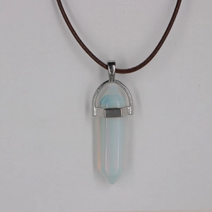 Macro detail of hexagonal opalite stone pendant with silver clasp on a braided cord