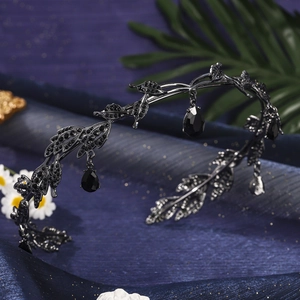 Detail of gothic black leaf crown featuring crystal water drop pendants and sparkling rhinestones