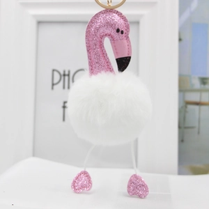 Detailed close-up of pink sequin flamingo keychain with white fluffy faux fur ball