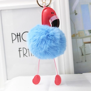 Détail d'un porte-clés flamant rose en peluche avec pompon bleu et anneau doré