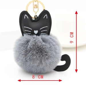 Detail showing the dimensions of the grey plush cat pompom keychain with gold hardware