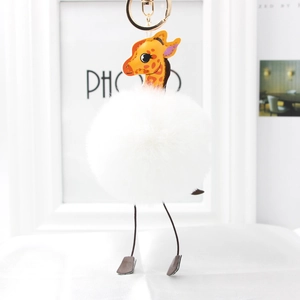 Cute giraffe plush keychain with large white fluffy faux fur pom pom and gold ring