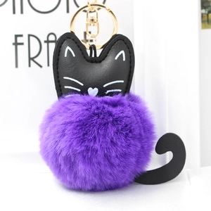 Detail of cute cat plush keychain featuring purple fur ball and black faux leather ears