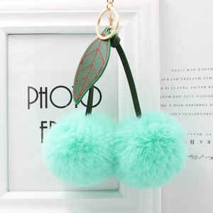Cute mint green faux fur cherry keychain with green leather leaves and golden ring