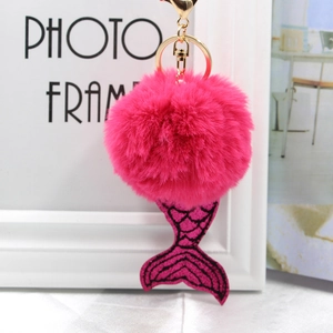 Détail du pompon en fausse fourrure fuchsia avec queue de sirène en sequins violets
