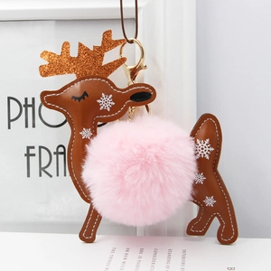 Detail of reindeer faux fur keychain with leather stitching and pink plush ball