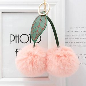 Pink faux fur cherry keychain with green leather leaves and gold metal ring fastener