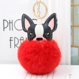 Dettaglio del portachiavi a forma di cucciolo con grande pompon rosso in ecopelliccia