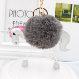 Detail of grey fluffy unicorn pompom keychain with holographic silver ears and pink mane