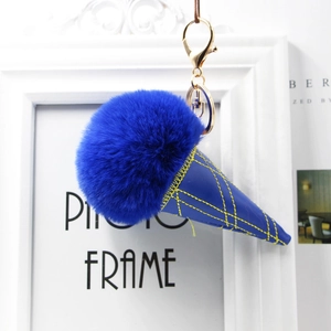 Detail of royal blue faux fur ice cream keychain with a textured cone and golden clasp