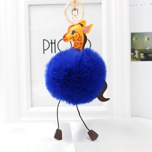 Close-up of bright blue faux fur giraffe keychain with gold metal buckle and cute details