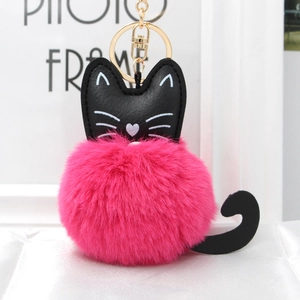 Close-up of cute cat plush keychain with embroidery details and gold lobster clasp