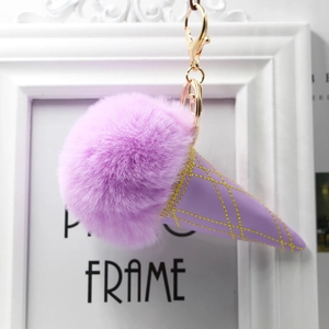 Detail of purple faux fur ice cream keychain with golden clasp and stitched cone