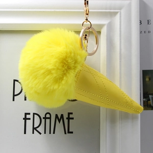 Detailed view of yellow faux fur ice cream cone keychain with gold metal buckle