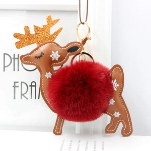 Christmas reindeer keychain with dark red faux fur ball and brown leather deer pendant