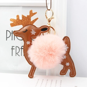 Close-up of reindeer keychain featuring a fluffy pink pompom and gold sequin antlers
