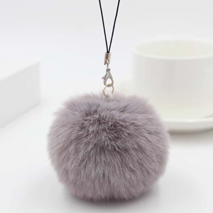 Detail showing the texture of an 8cm grey plush ball keychain with a metal clasp