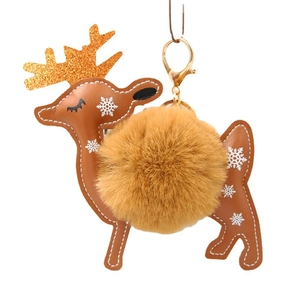 Brown reindeer fur ball keychain with gold sequin antlers and white snowflake print