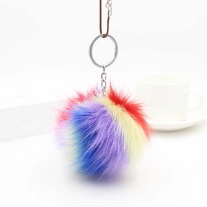 Detailed close-up of a fluffy rainbow faux fur keychain with a silver ring and leather strap