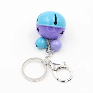Close-up of star cutout bicolor bells with silver metal lobster clasp and key ring keychain