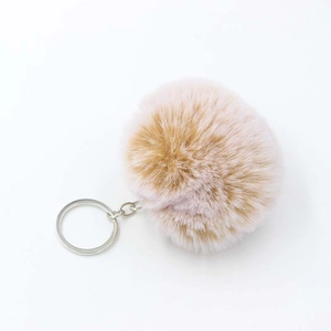 Close-up of soft pink faux rabbit fur pom pom keychain with silver metal ring