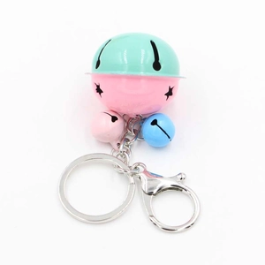 Detail view of colorful bell keychain with star cutouts and silver lobster clasp