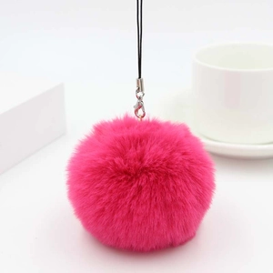 Detail of soft bright pink faux rabbit fur pom pom keychain with silver lobster clasp