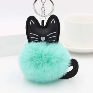 Detailed macro view of mint green plush cat pom-pom keychain with leather ears