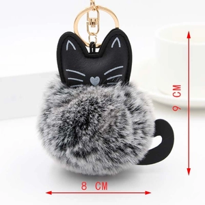 Detail showing plush cat keychain dimensions of 9cm by 8cm with gold hardware