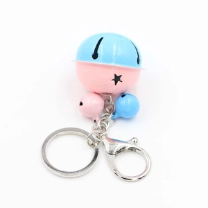 Close-up of pink and blue metal bells with star pattern on a silver keychain ring