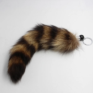 Detailed macro view of large faux fox fur keychain with brown and black stripes
