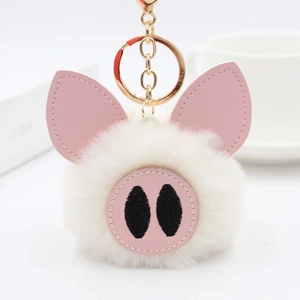 Vue détaillée du porte-clés cochon en peluche blanche avec fermoir mousqueton doré élégant