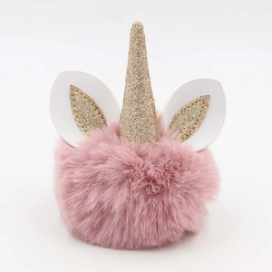 Detail of pink faux fur unicorn keychain with gold sequined horn and glittery ears