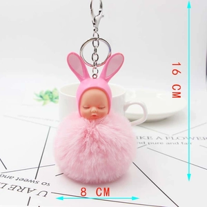 Detail of 16cm pink sleeping baby plush pompom keychain with rabbit ears and metal ring