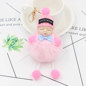 Porte-clés bébé en peluche rose avec pompon en fourrure et nœud à carreaux bleus