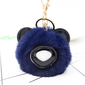 Détail d'un porte-clés ours en peluche bleu foncé avec fermoir métallique doré de qualité