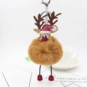 Detailed view of reindeer plush pom pom keychain with red hat and silver clip