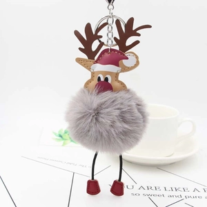 Detailed view of reindeer pompom keychain with reindeer antlers and a red Christmas hat