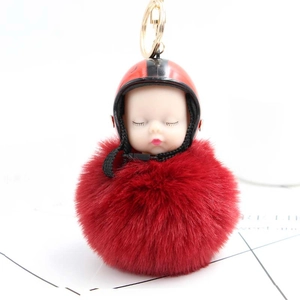 Cute plush sleeping baby doll keychain with red helmet and fluffy pompom ornament