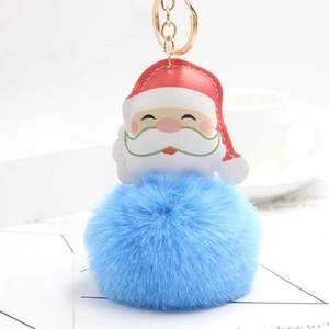 Detail of Santa Claus faux leather charm with a light blue faux fur ball and gold keyring