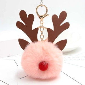 Détail d'un porte-clés boule en peluche renne de Noël rose avec fermoir en métal doré