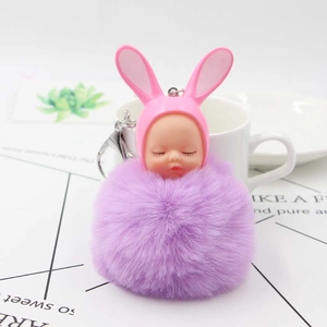 Pink rabbit sleeping doll keychain with purple faux fur pompom and metal lobster clasp