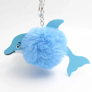 Cute blue dolphin plush pompom keychain with faux leather details and silver metal hook