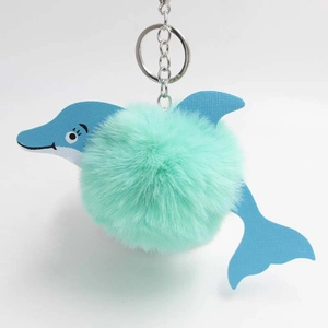 Detail of cute mint green faux fur pompom dolphin keychain with silver metal ring